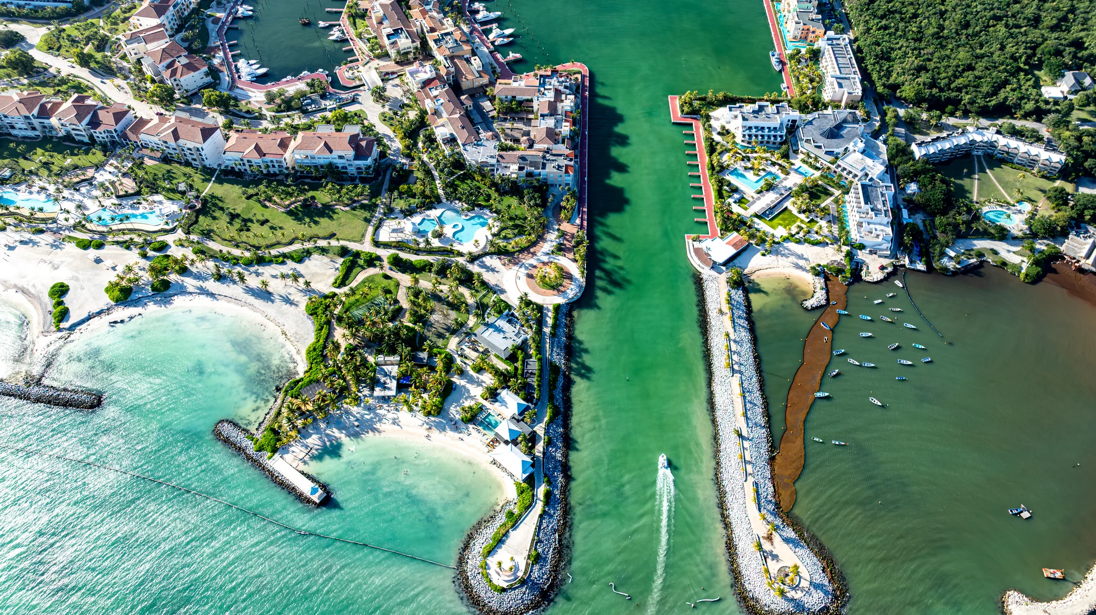 Entrance to the Cap Cana marina between beaches and waterfront buildings.