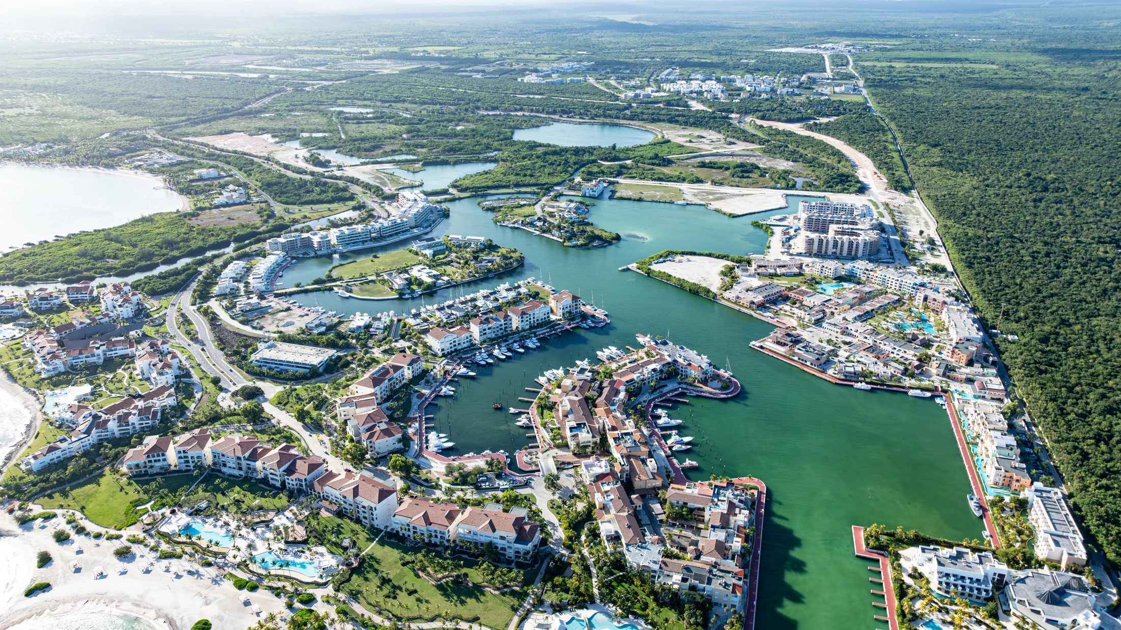 Wide aerial view of Cap Cana’s marina and the surrounding green landscape.
